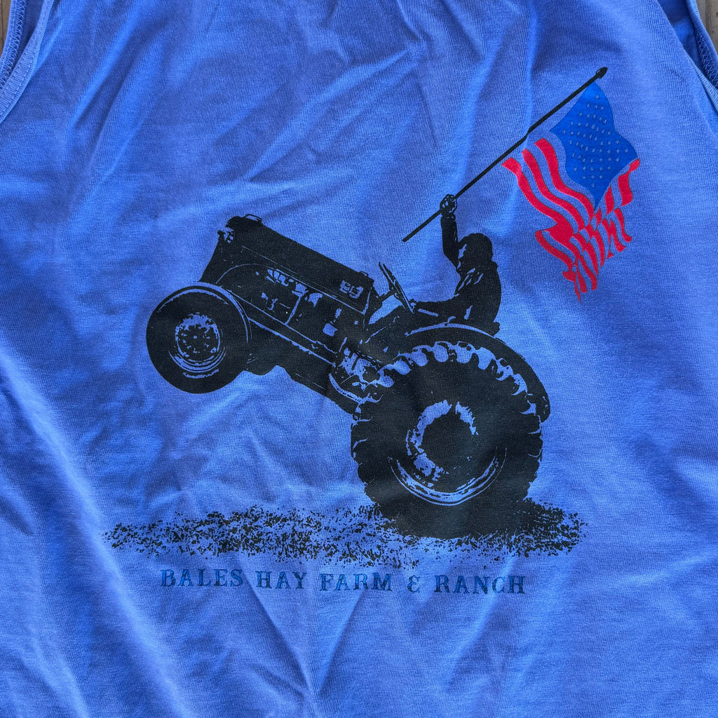 Blue tank top with graphic design on a wooden surface