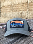 Load image into Gallery viewer, This hat is both well-made and comfortable to wear that features the first patch we ever designed! It represents the horses we feed, and the landscape we live in.  

